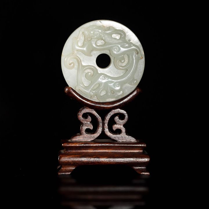 十八世紀 白玉雕螭龍璧（附木座） A Chinese carved white jade chilong bi, 18th century