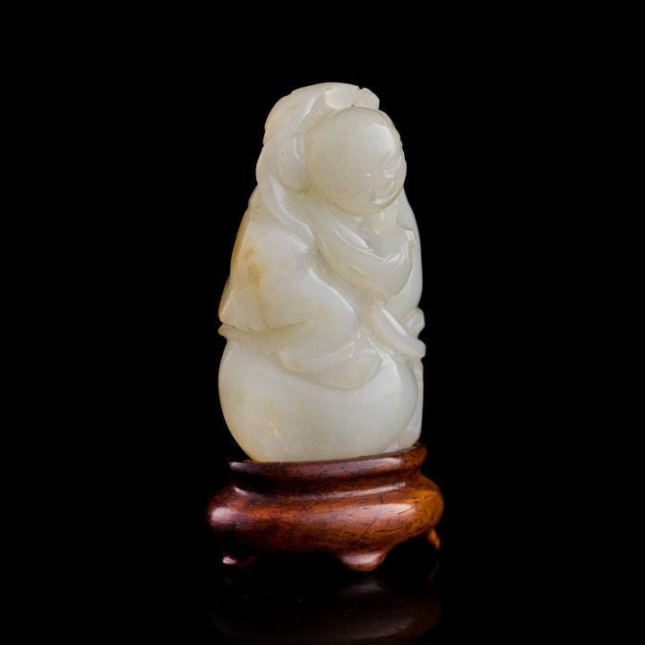 十九世紀早 白玉童子(附木座) A Chinese white jade boy, early 19th century