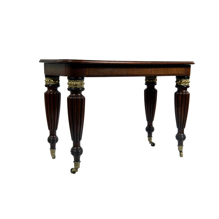 A Classical brass-mounted and parcel-ebonized satinwood and mahogany tea table