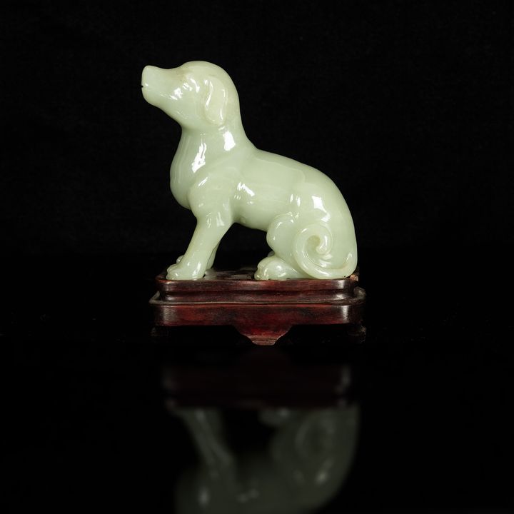 民國 青玉狗擺件 (附木座) A Chinese carved celadon jade dog statue, Republic period