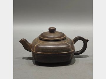 An old purple clay teapot