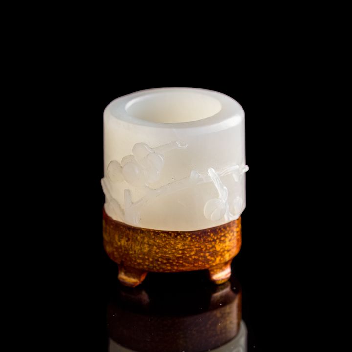 十八世紀 白玉雕梅花扳指(附木座) A Chinese carved white jade archer's ring, 18th century